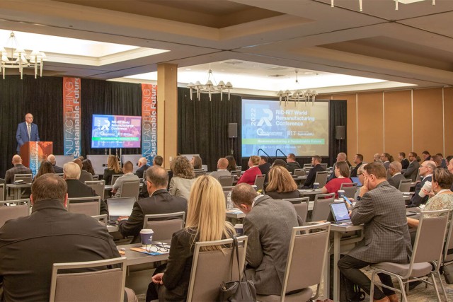 An audience listens during a conference presentation