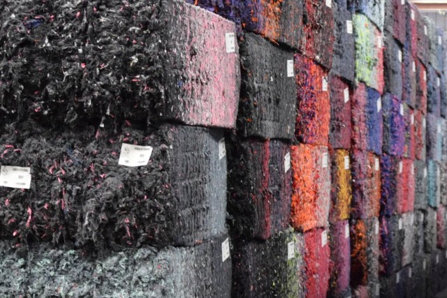 Colorful recycled fiber bales reflect the vibrant textiles they formerly were