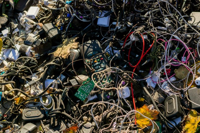 a giant pile of old electronics and cords in a landfill