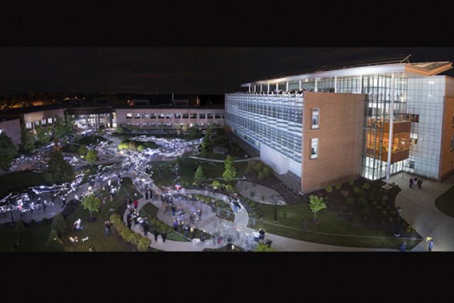 People gathered outside lit up buildings