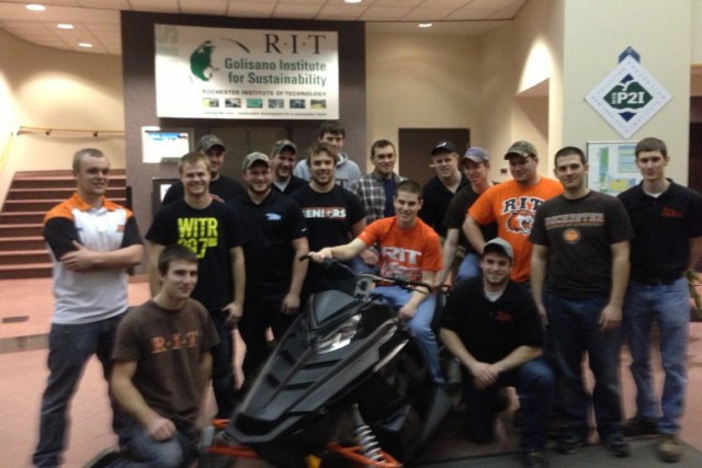 People posing with vehicle