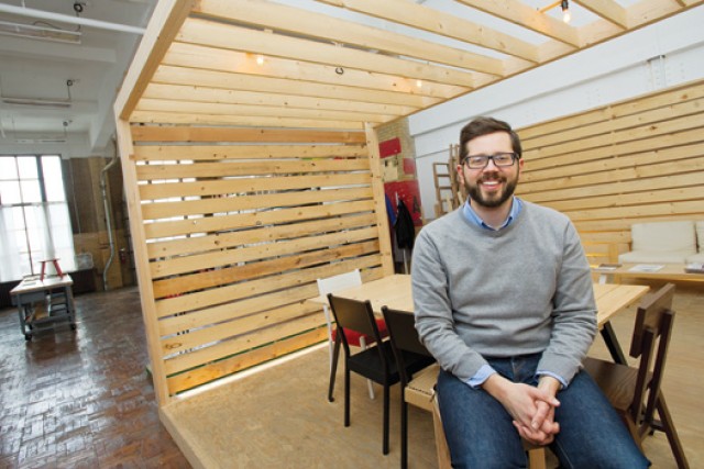Person posing next to custom desk