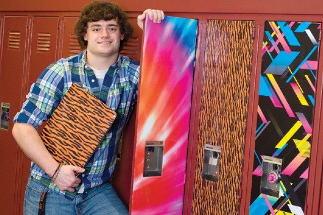 Person posing next to decorative lockers