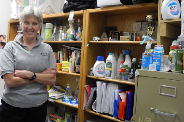 Professor posing near supplies