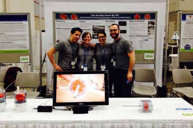 People posing in front of presentation