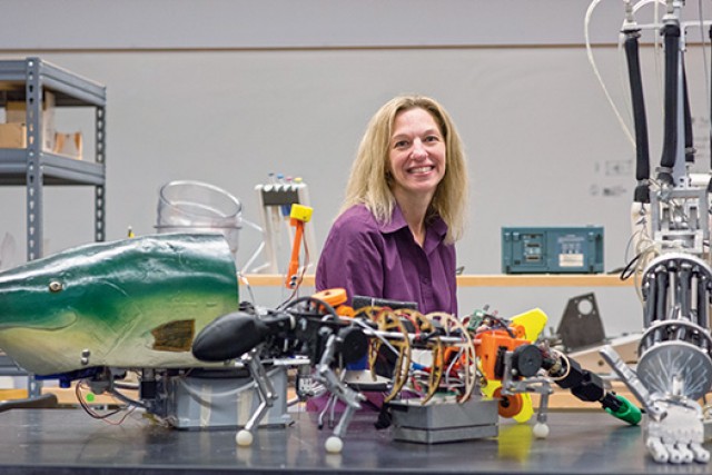 Person posing in behind robot