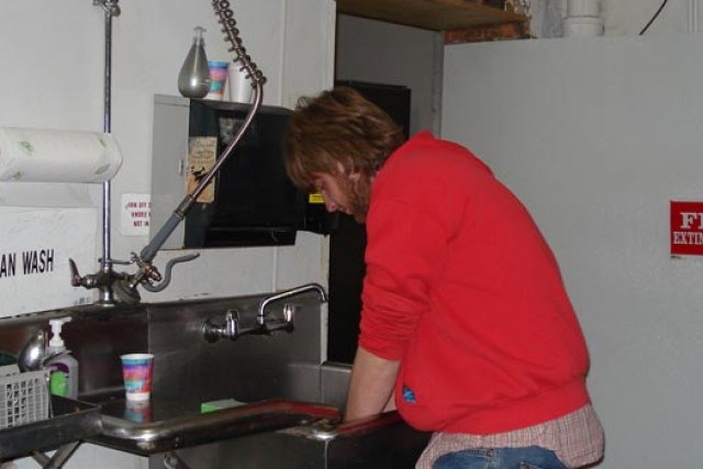 Student washing their hands in a sink