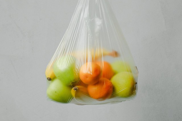 clear plastic bag of apples, pears, bananas, and oranges.