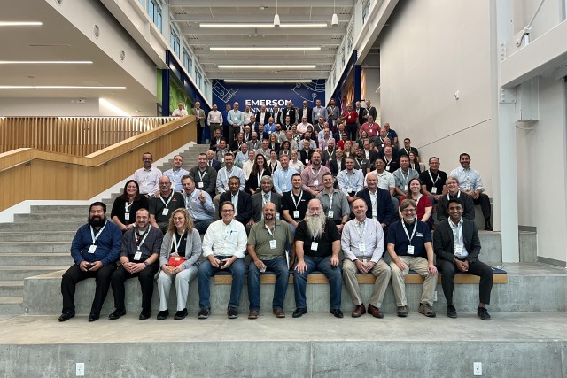 Attendees from a conference pose for a group photo 