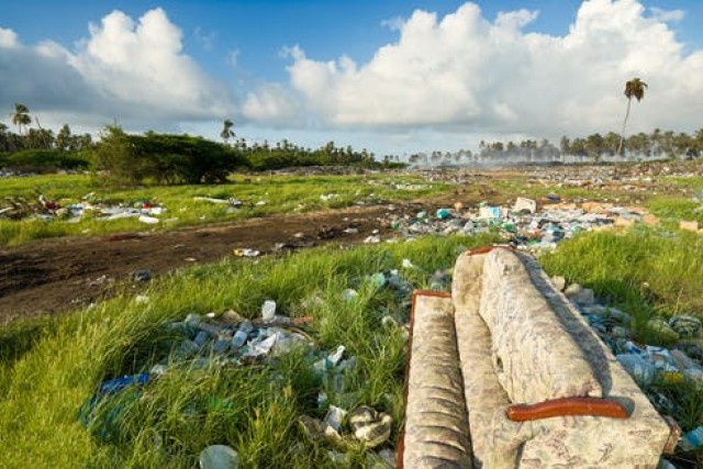 green space covered in trash.