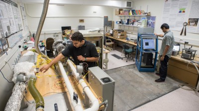 Workers calibrating a machine before running a test