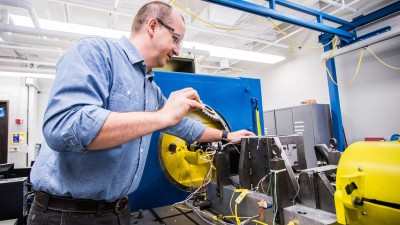 A man in goggles testing transmission dynamometer.
