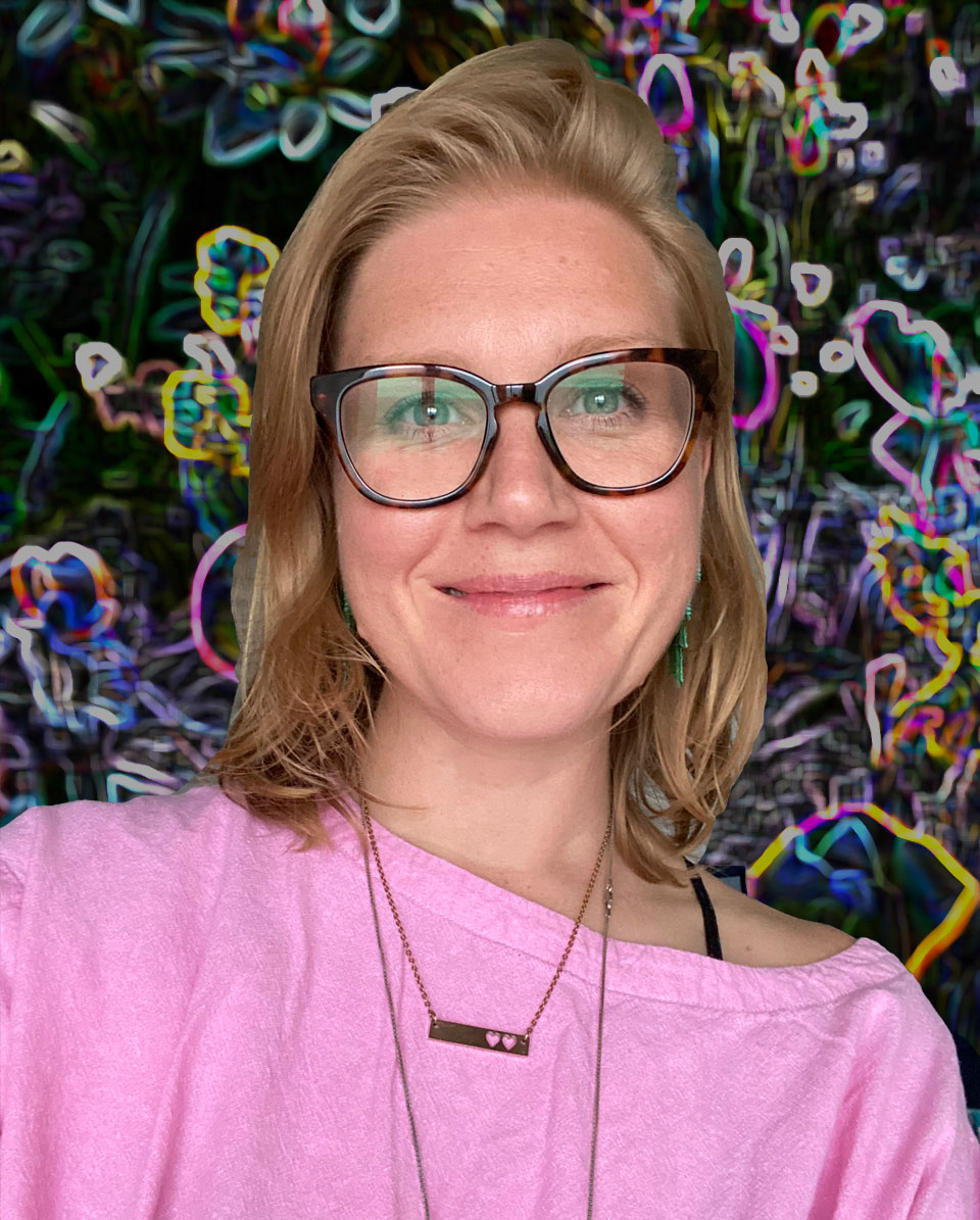 headshot of a smiling white blond woman with glasses in front of a floral pattern