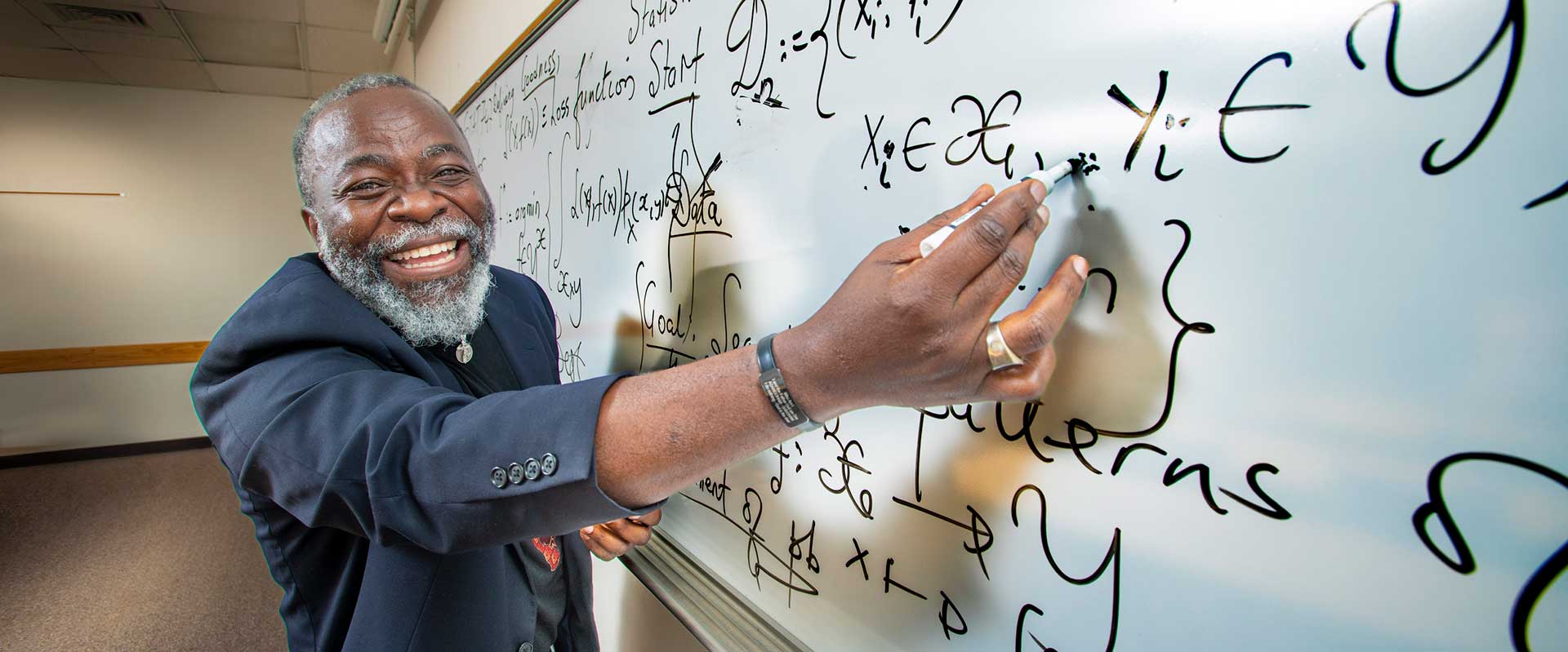 Instructor writing on a whiteboard