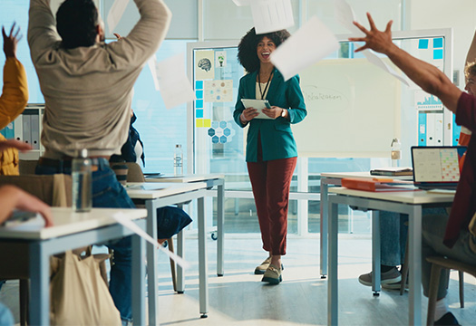 Students, throw paper and celebration in classroom with teacher, success and achievement at university. College professor, men and women with exam documents, test results and goals with education