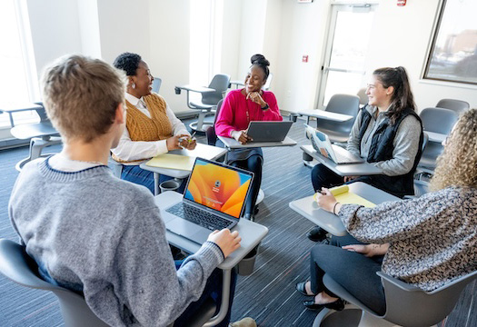 Students in mock discussion in classroom scenario.