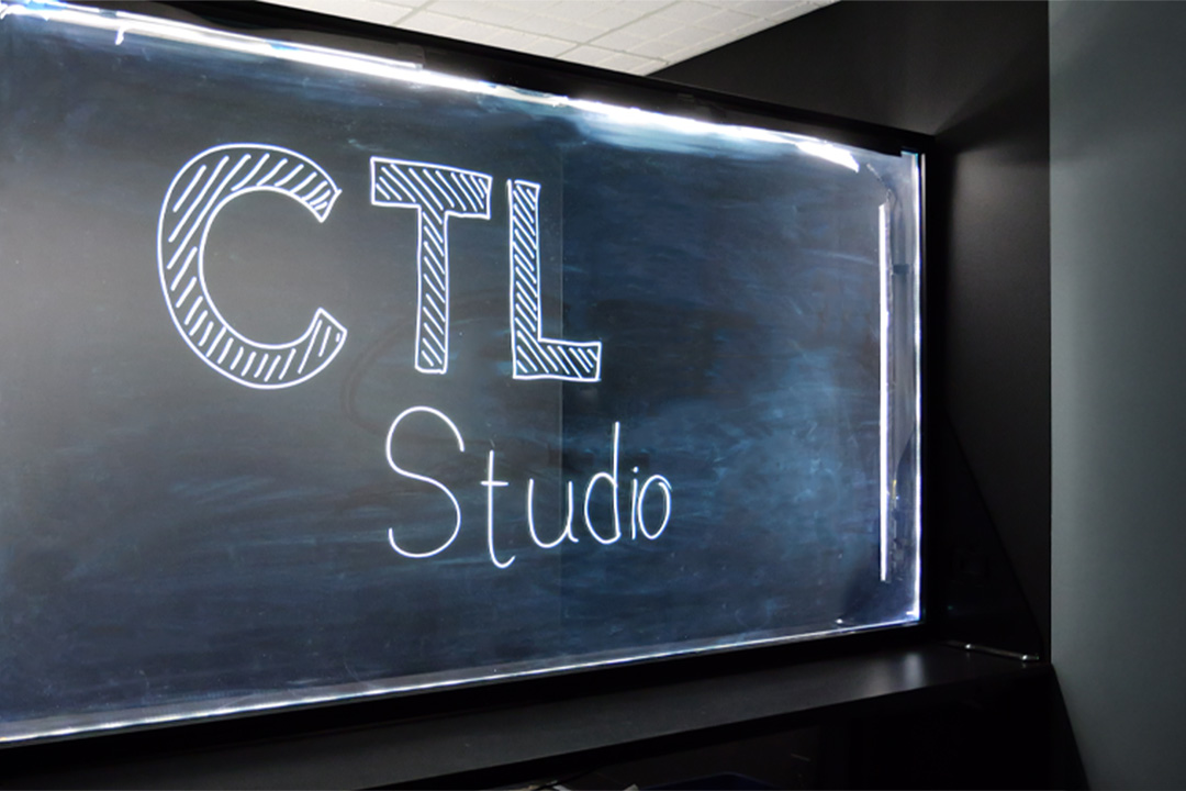 image of a lightboard set against a dark studio background with the words CTL Studio written on the glass