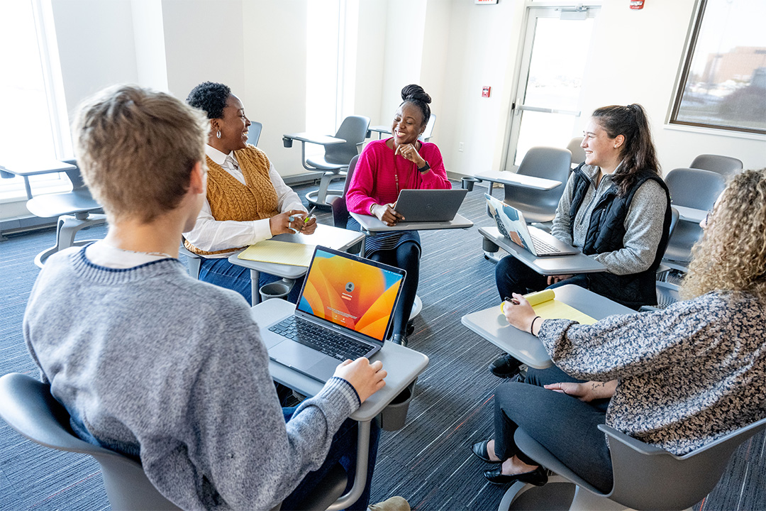 Students in mock discussion in classroom scenario.