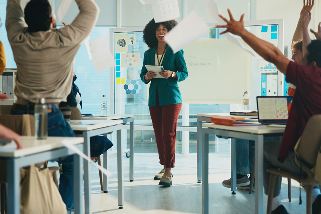 Students, throw paper and celebration in classroom with teacher, success and achievement at university. College professor, men and women with exam documents, test results and goals with education