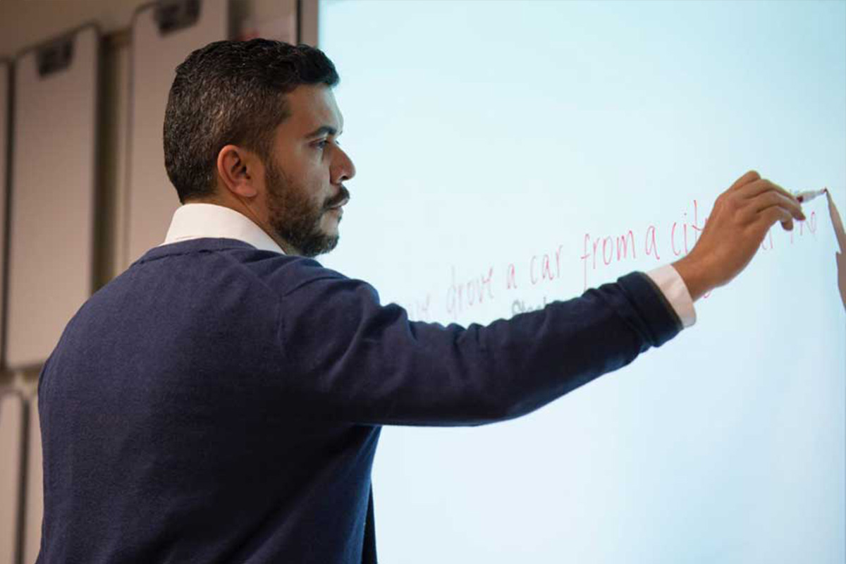 Instructor writing on a whiteboard