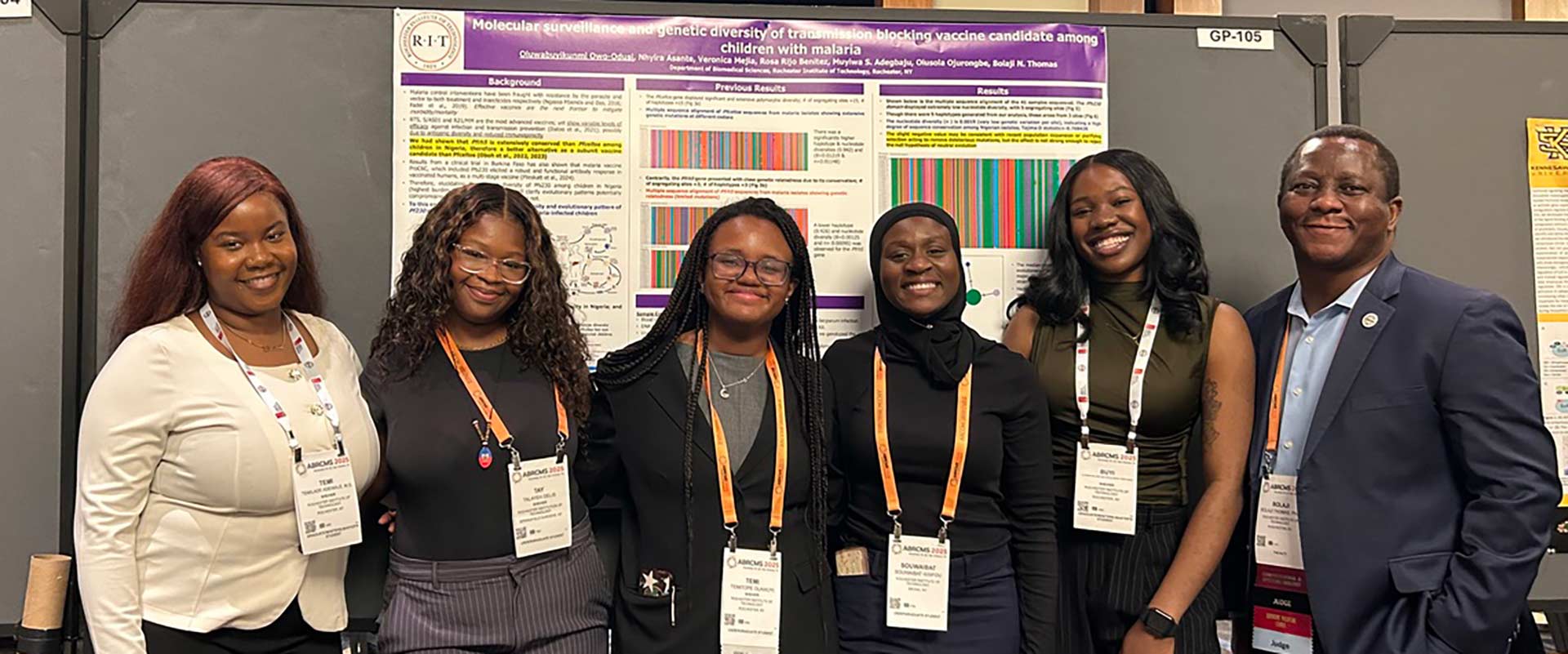 professor stands with five students in front of a scientific poster.