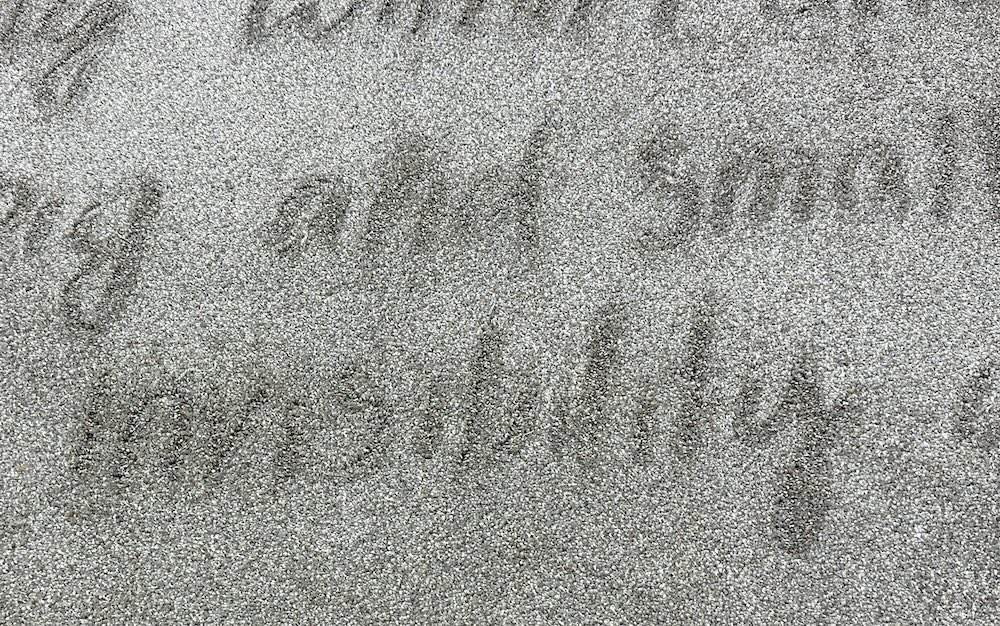 grey pile rug with handwritten script