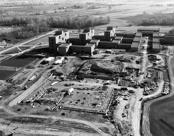 a black and white aerial photograph with a view of an entire college campus under construction.