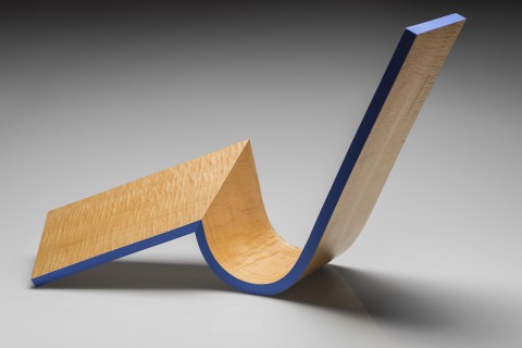 Sculptural form of a flat plane merging into a swoop wave form. Natural wood with a blue painted accent edge 