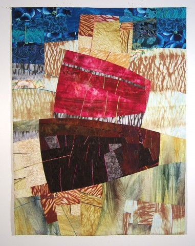 Abstract design created with colorful dyed red and brown fabric pieced together and graphic elements printed 