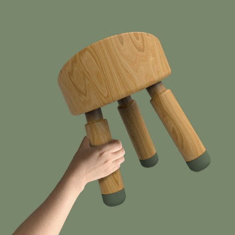 Three leg stool held in the air by a hand