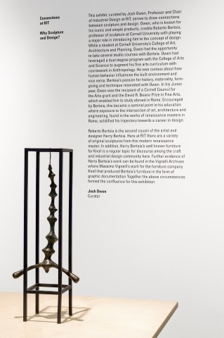 A metal cage form with a suspended abstract human form with wall text.