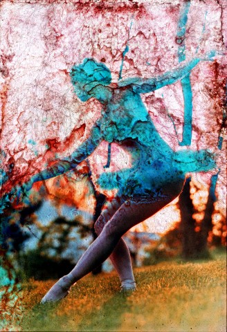 A blurred and degraded color photo image of a tutu wearing ballerina in a pose with sunset and tree silhouettes backdrop