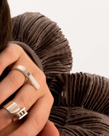 Close up of hand with knuckles wearing silver rings