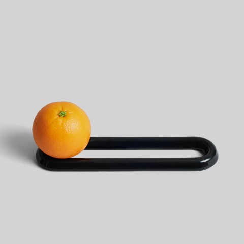 Oblong black loop shape with an orange on top