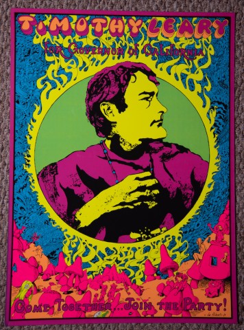 a poster in saturated color and dense psychedelic detailed patterns swirling around a profile of a man with purple hair wearing a bead necklace with text above 'Timothy Leary'..