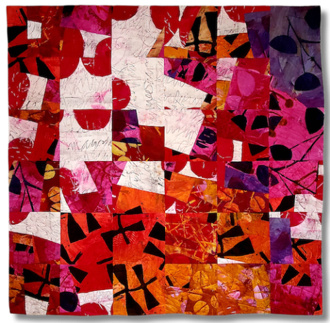 a painterly fabric quilt with an overriding grid that displays areas of bright red, white and pink accented with black graphic forms.