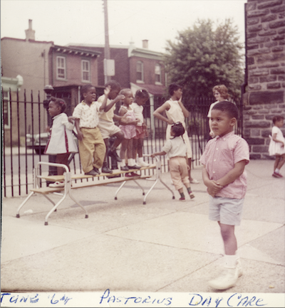 a faded color photograph of children playing in a school yard.