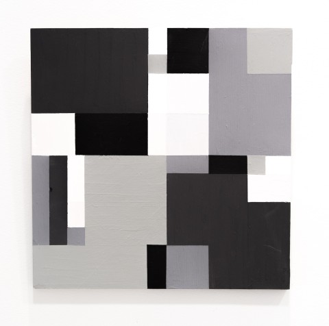a square panel with blocks of black, grey and whites based on a grid design.