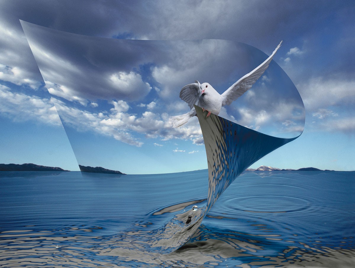Manipulated photographic image of a white dove in a whirlpool of water with blue sky and clouds