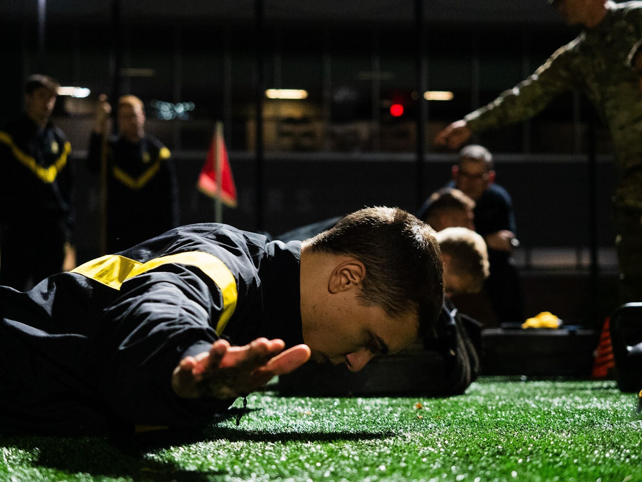 A cadet in physical fitness uniform doing hand release push ups
