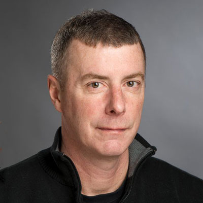 headshot of male wearing black shirt.