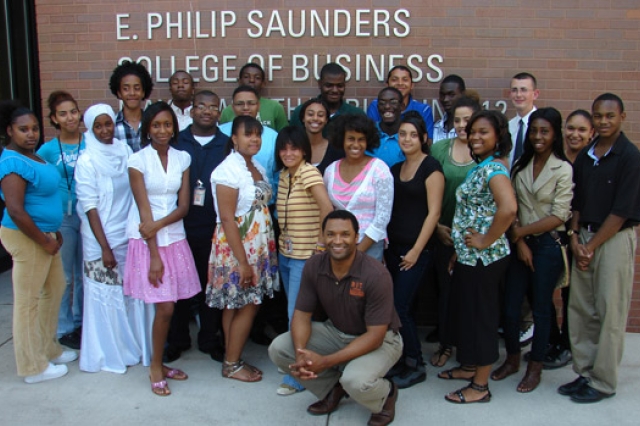 People posing in front of classroom building