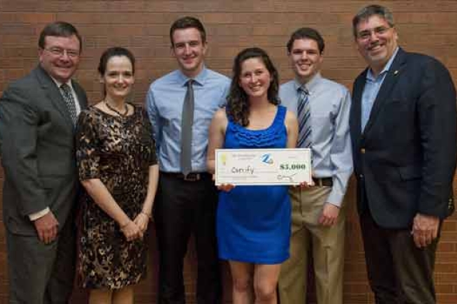 People posing with check at event