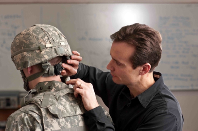 Person fixing another person's helmet