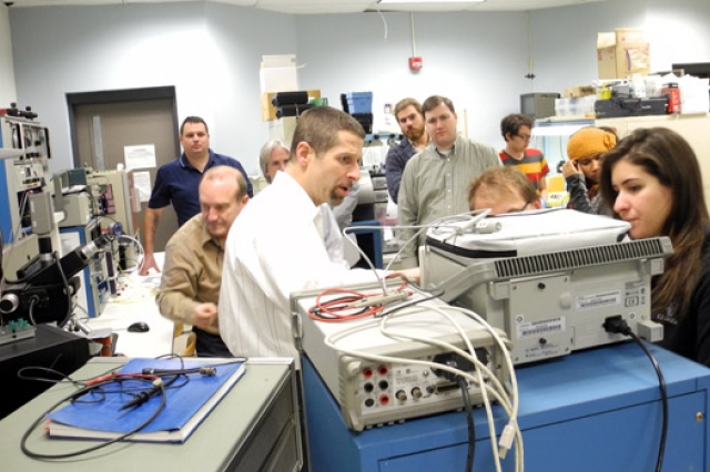 People gathered around machine in classroom