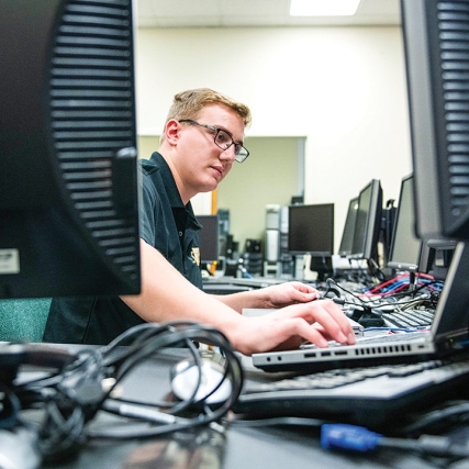 Student works on multiple computers.