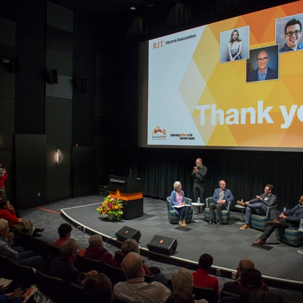 Overhead view of presenters sitting on stage.