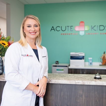 Chrysa Charno at the front desk of childrens' urgent care office.