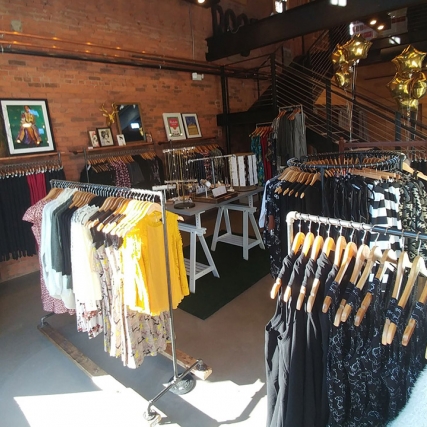 Racks of clothes at boutique store.