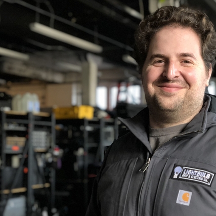 A portrait of Adam Richlin in his warehouse space.